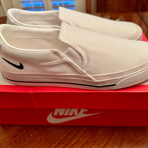 Nike Shoes - **NIB*** Nike Woman’s White Slip-On Canvas with Black Nike Swoosh- size 10